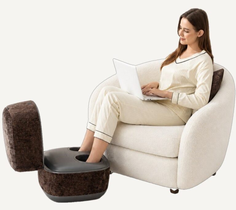 Woman with a laptop resting her feet in an open brown SolePod Pro